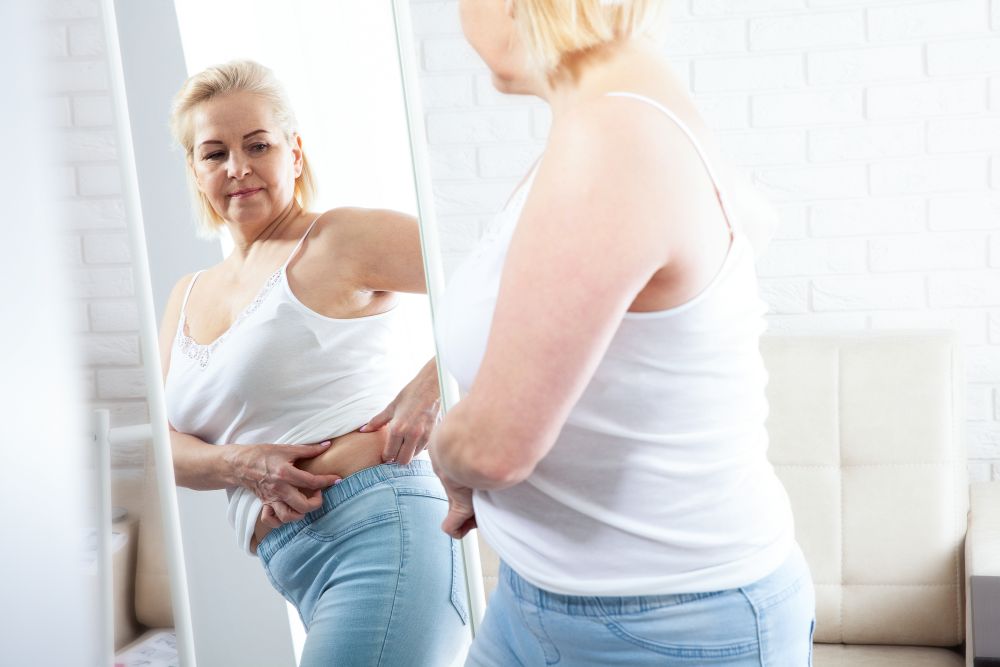 Menopause is not simply a reproductive transition. It is also a metabolic transition. The appearance of belly fat may be one of the most visible signs of that shift, but it is only part of a larger story involving hormones, muscle mass, inflammation, insulin sensitivity, and cardiovascular health.